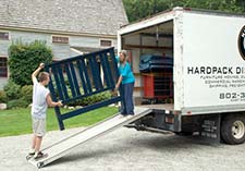 two workers loading a truck